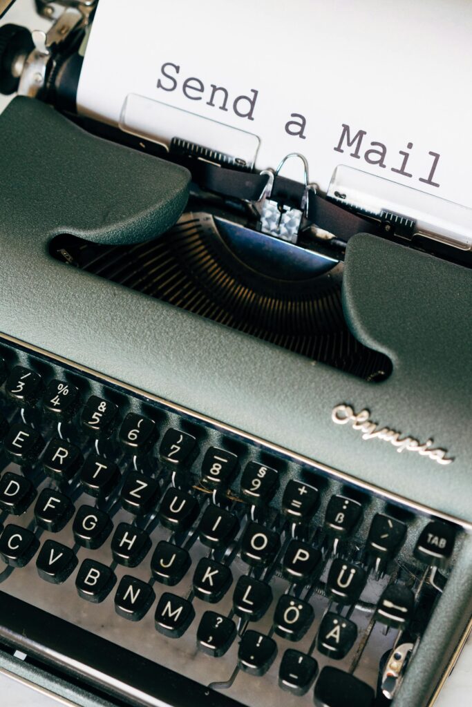Close-up of a vintage Olympia typewriter with 'Send a Mail' typed.